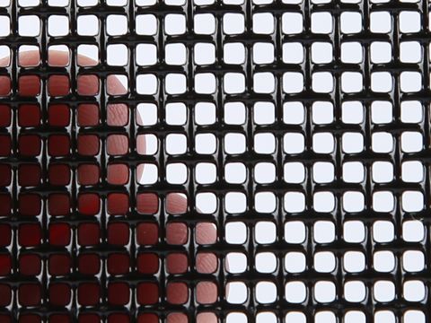 A piece of 11 mesh SS316 security screen in a man’s hand