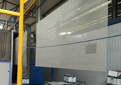 Stainless steel mesh screen is handing up before powder coated in workshop.